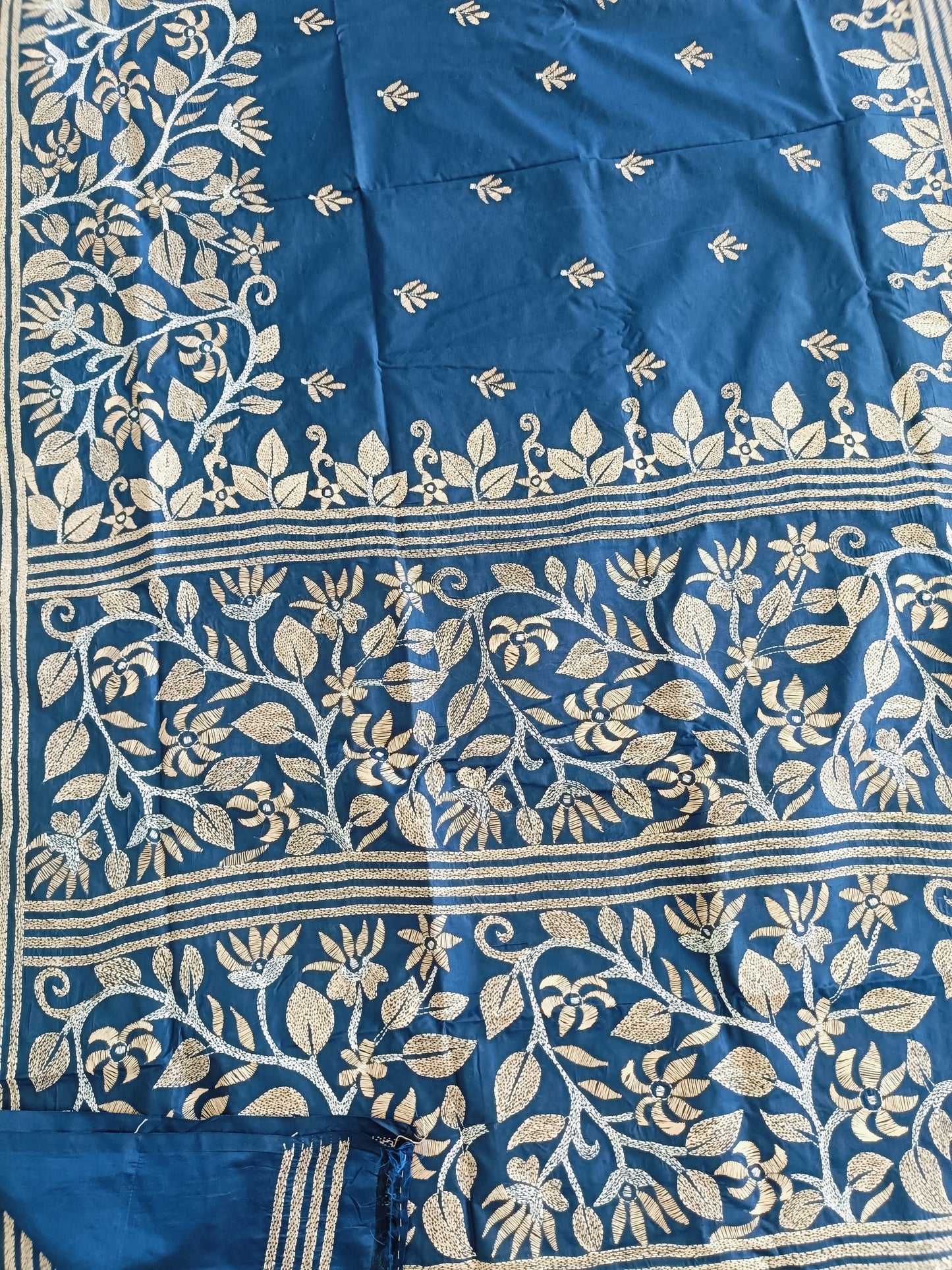 Blue fabric with intricate white floral patterns