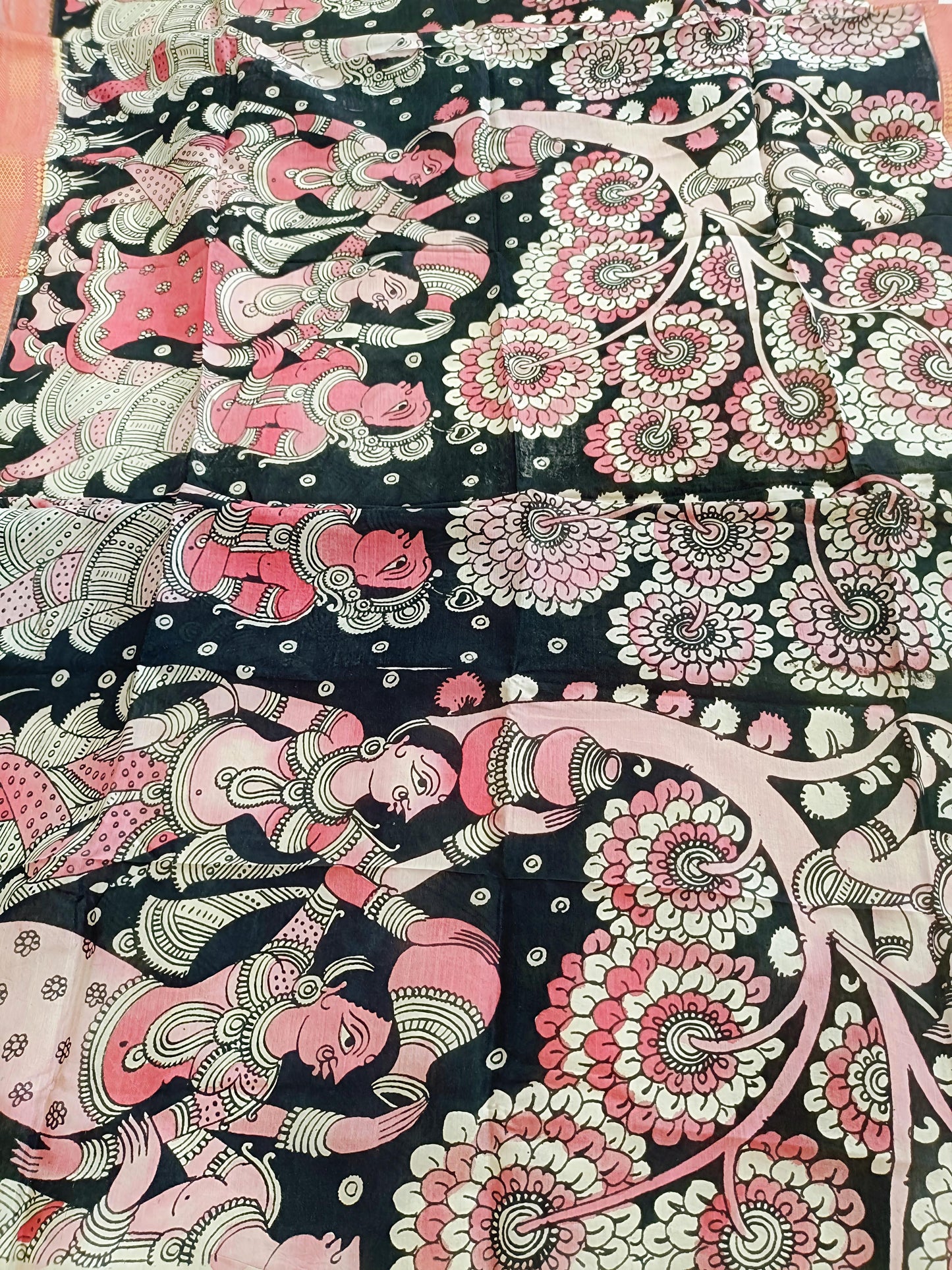 Decorative fabric with intricate patterns of women and flowers on a black background