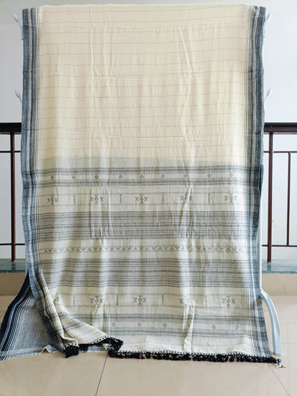 Beige and black striped fabric draped over a chair with a neutral background