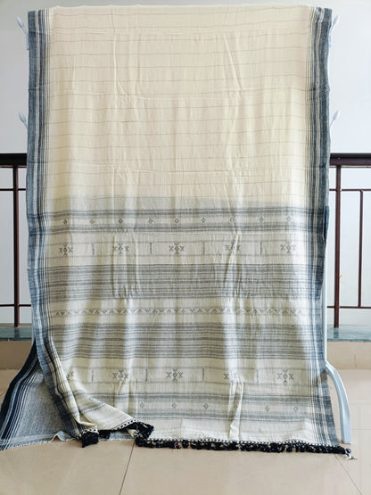Beige and black striped fabric draped over a chair with a neutral background