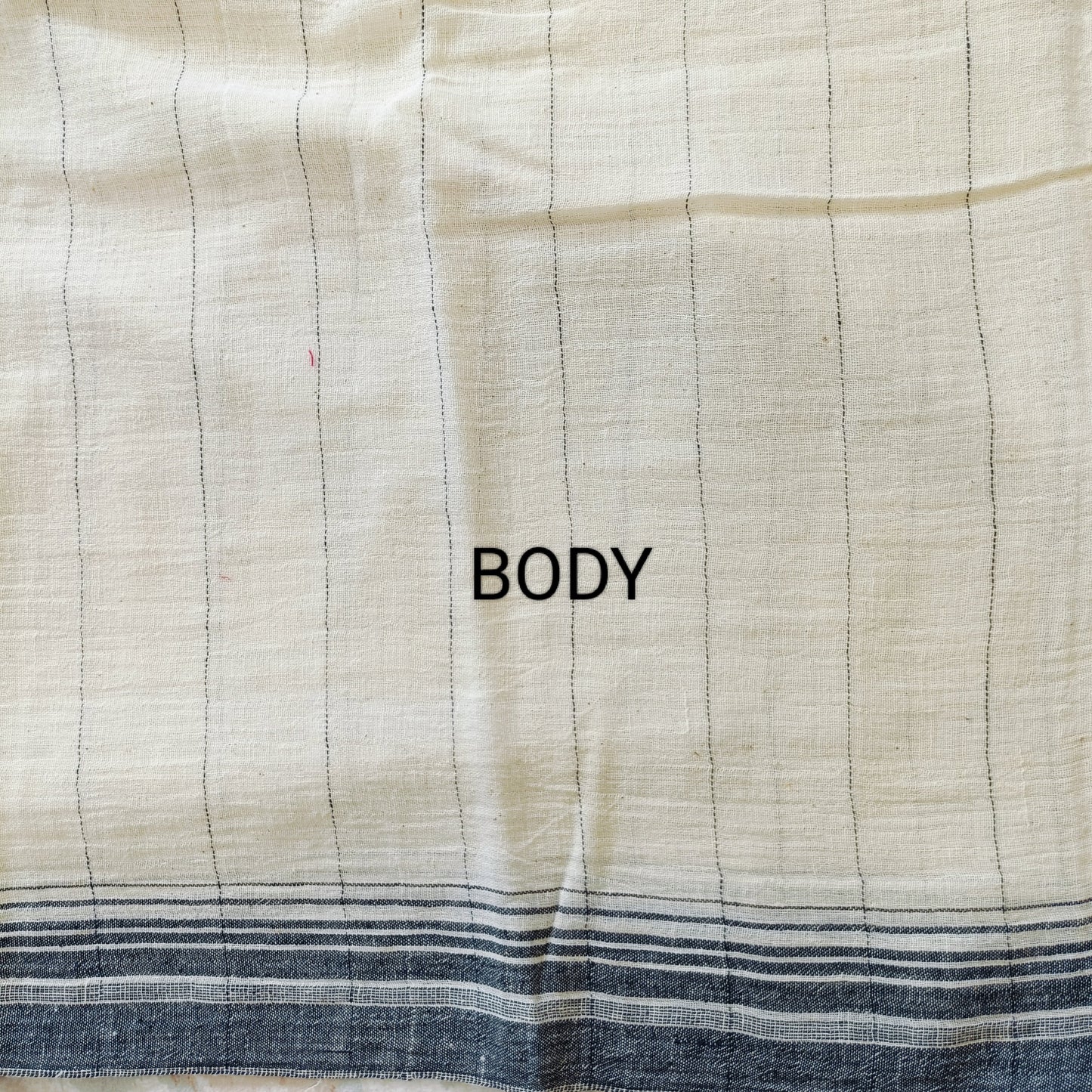 Textile fabric with 'BODY' label on a checkered pattern