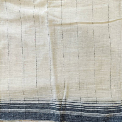 Close-up of a fabric with horizontal lines and blue stripes at the bottom