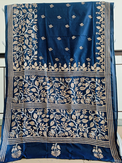 Blue saree with white floral patterns on a plain background