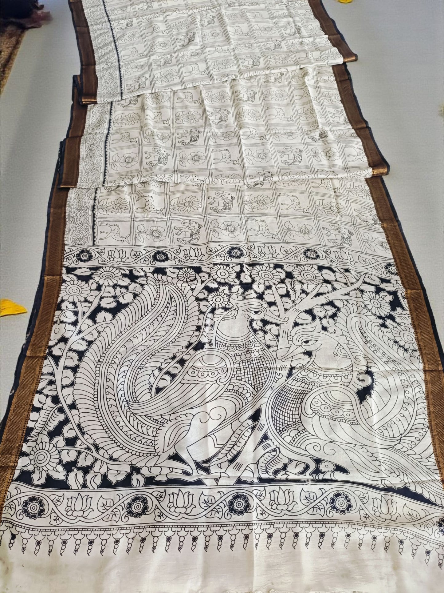 Decorative fabric with intricate black patterns on a white background