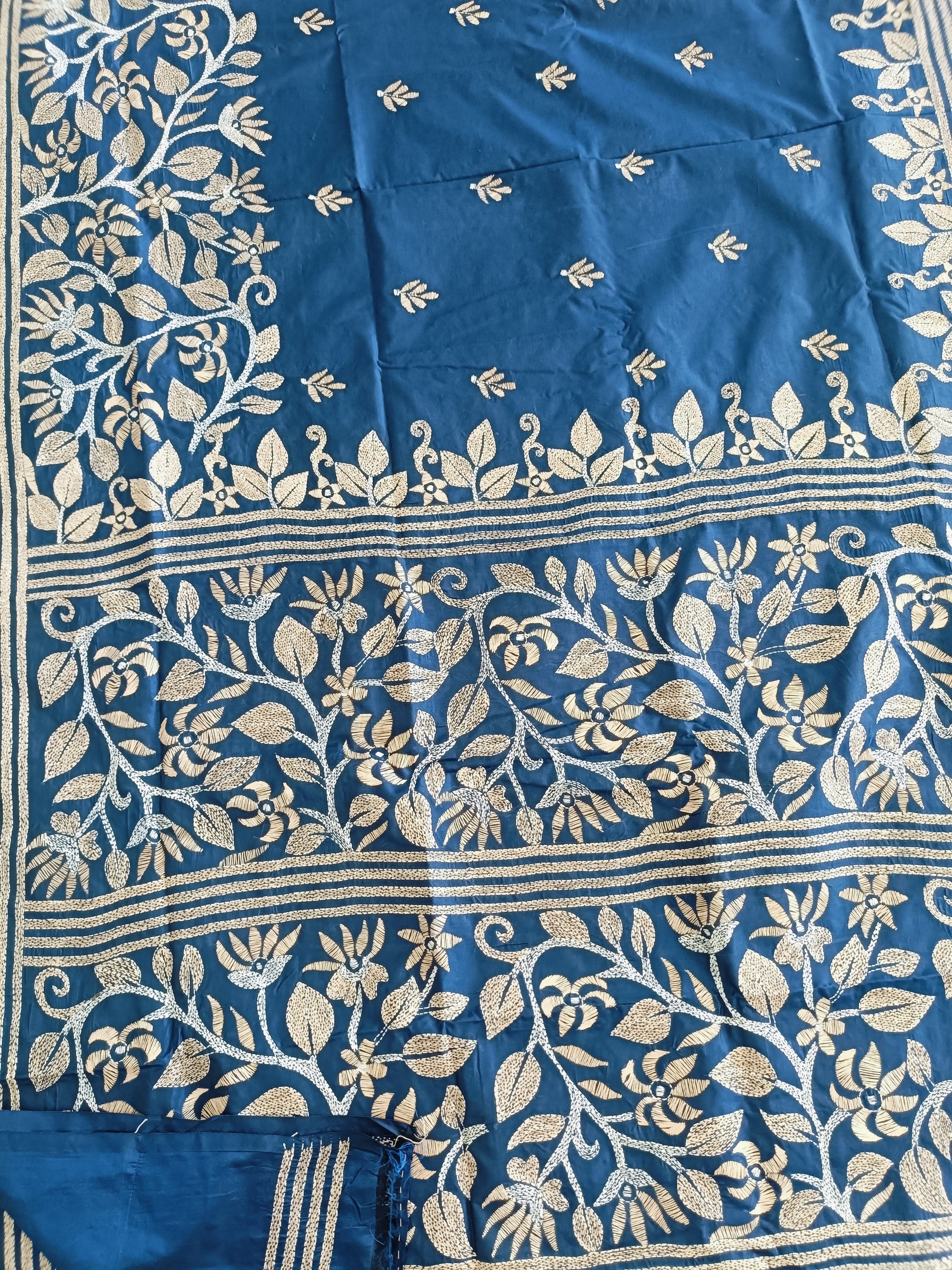 Blue fabric with intricate white floral patterns