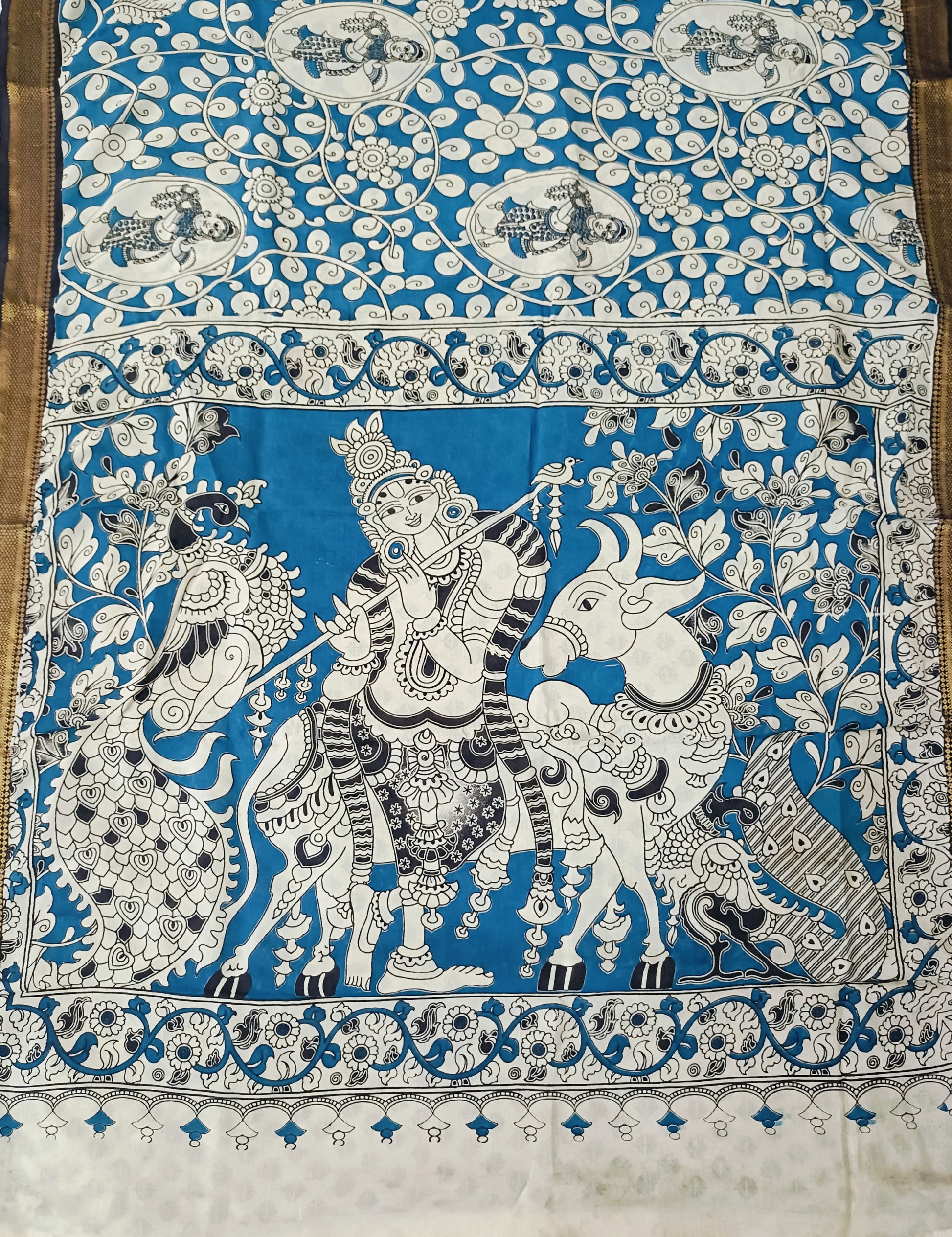 Decorative fabric with intricate black and white patterns on a blue background