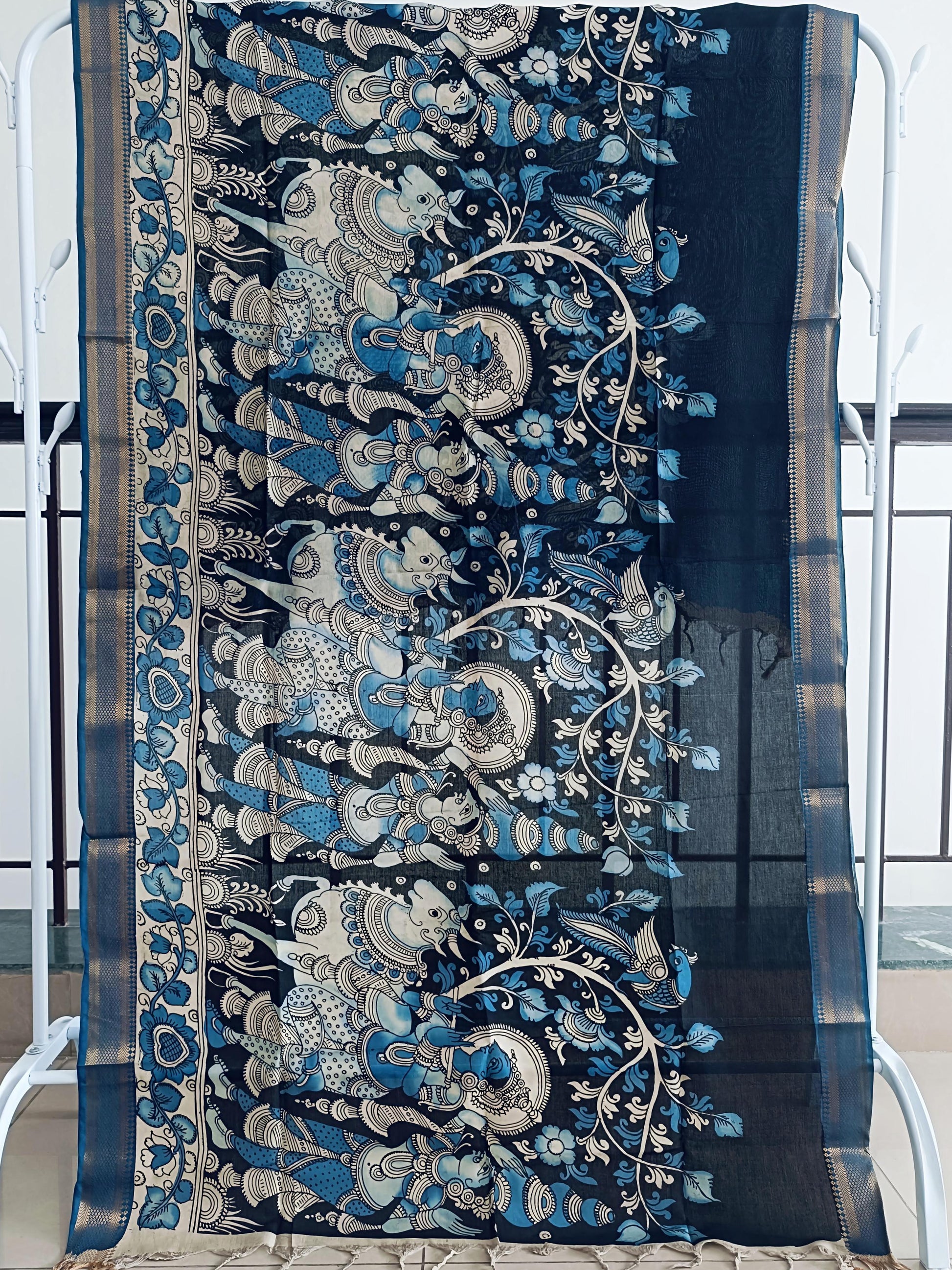 Decorative blue and silver fabric with intricate patterns on a chair.