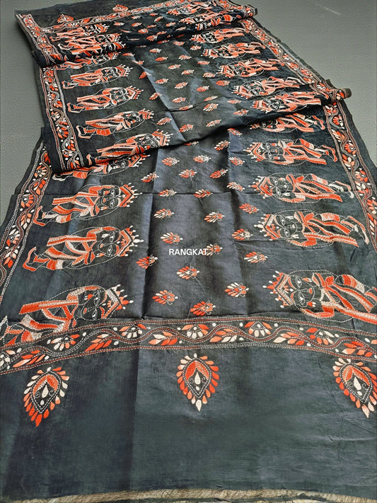 Dark fabric with intricate orange and white patterns, labeled 'Rangkali'.