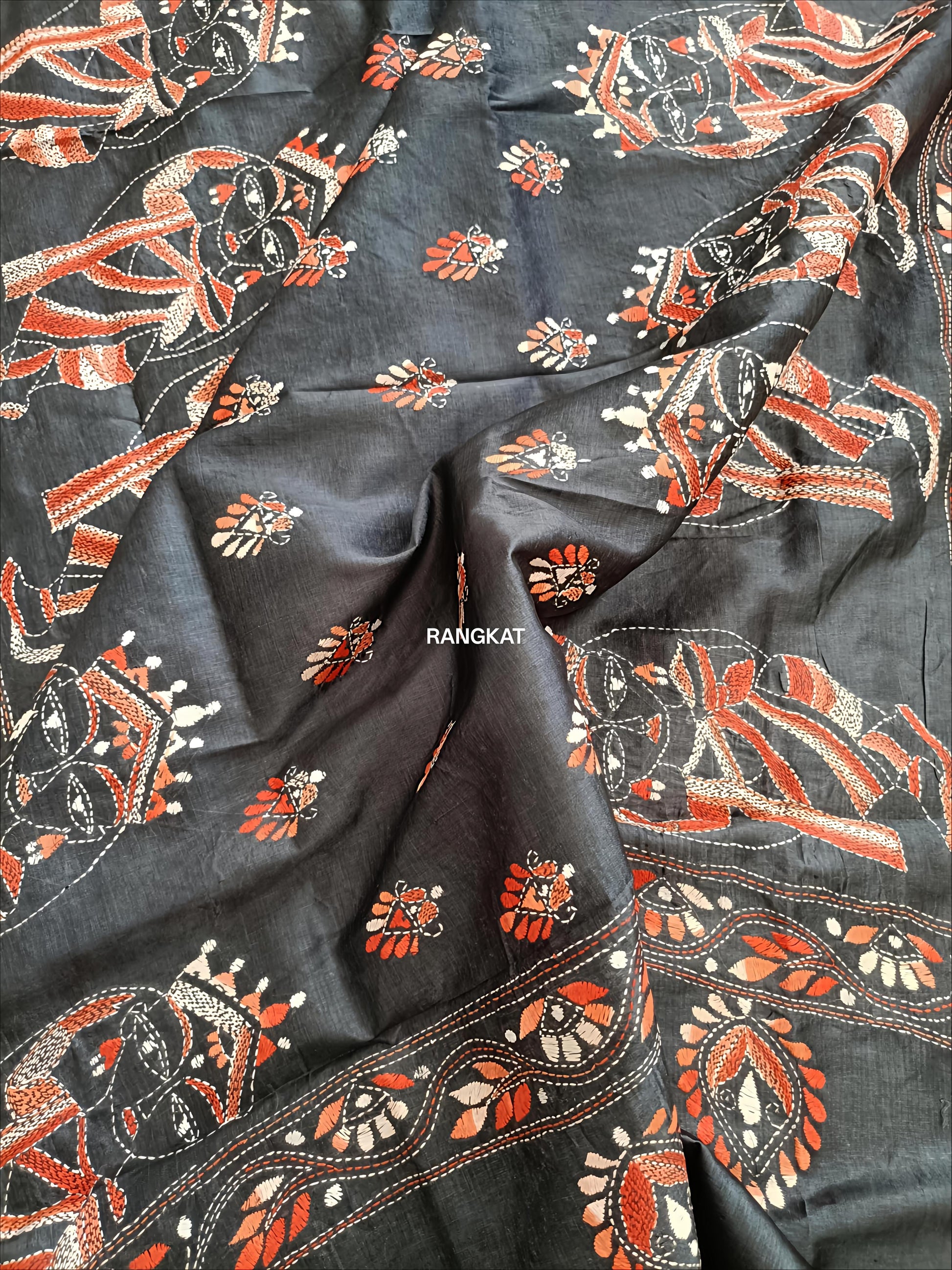 Black fabric with intricate orange and white patterns, featuring the brand 'Rangkat'.