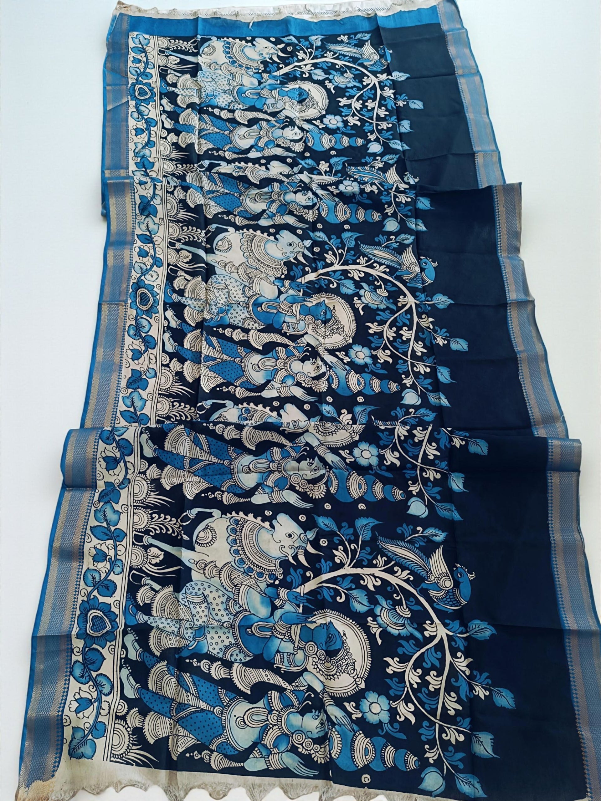 Navy blue fabric with intricate silver and white floral patterns on a white background