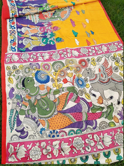 Colorful fabric with intricate designs and patterns, including a figure and floral elements.