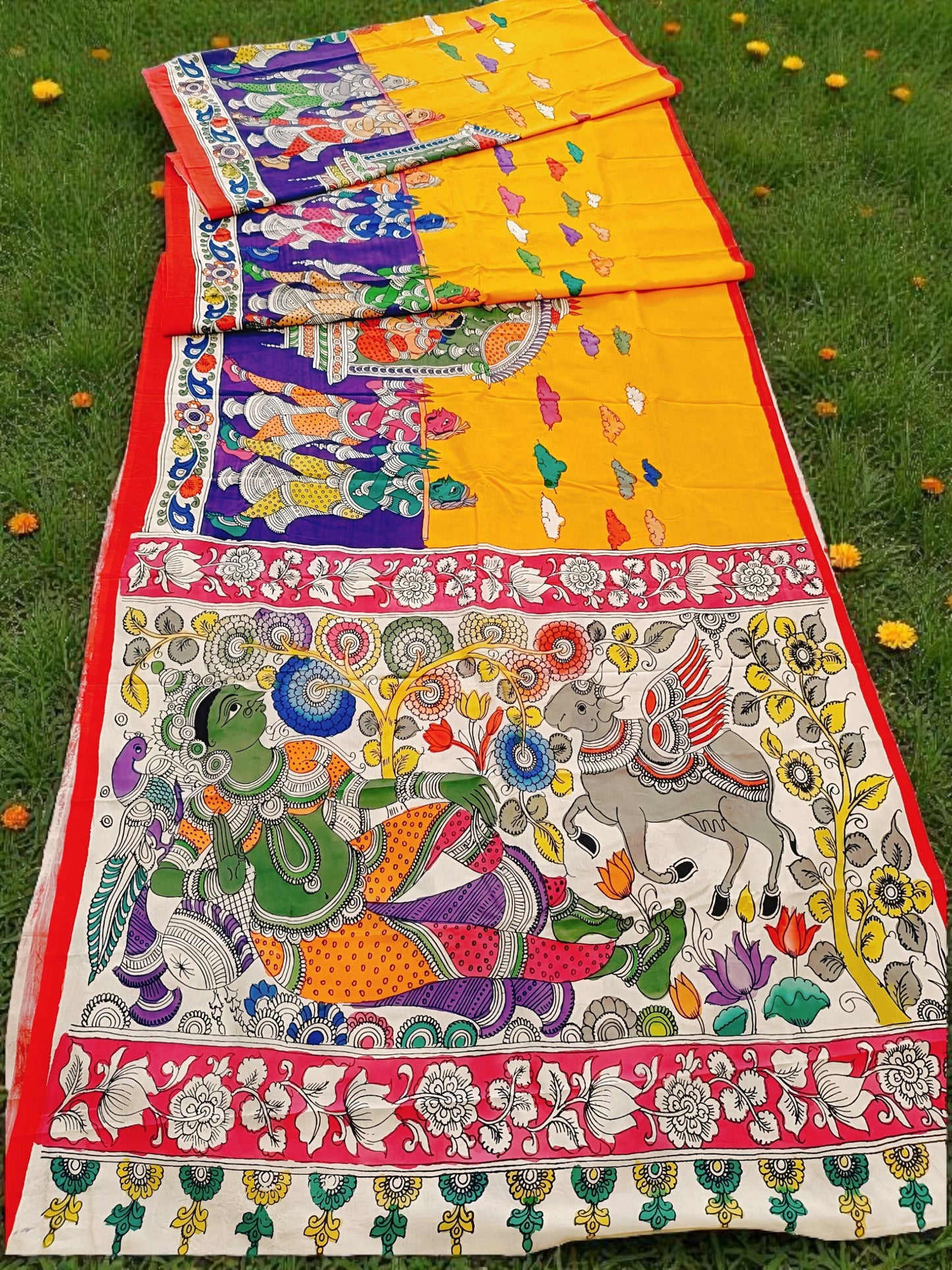 Colorful traditional fabric with intricate designs on a grassy background