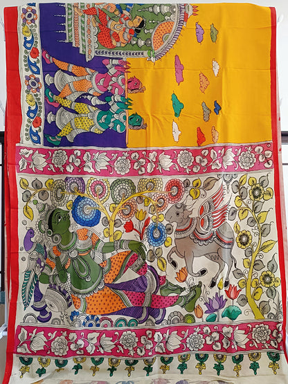 Colorful fabric with intricate designs of elephants and other elements on a yellow background