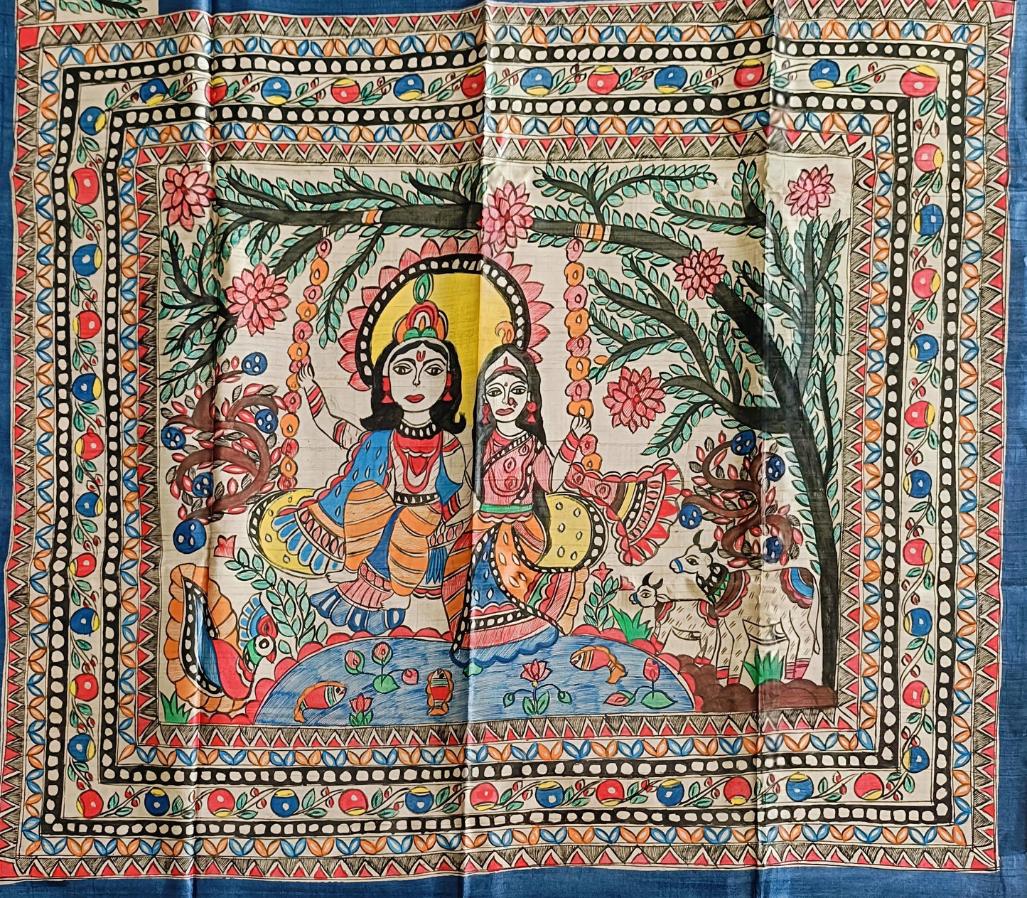 Colorful tapestry with a traditional design of two figures under a tree, surrounded by animals and nature elements.