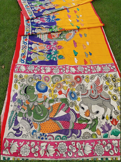 Colorful traditional fabric with intricate designs on a grassy background
