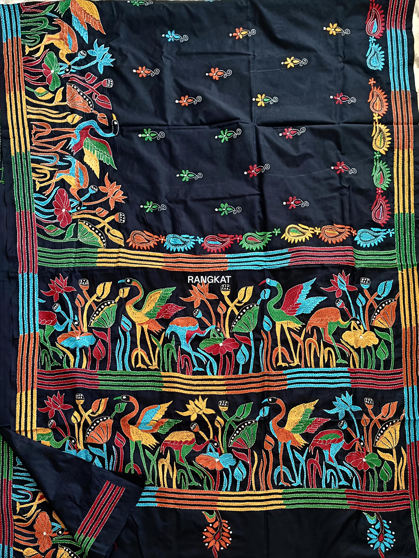 Colorful fabric with intricate patterns and 'Rangkat' branding on a black background