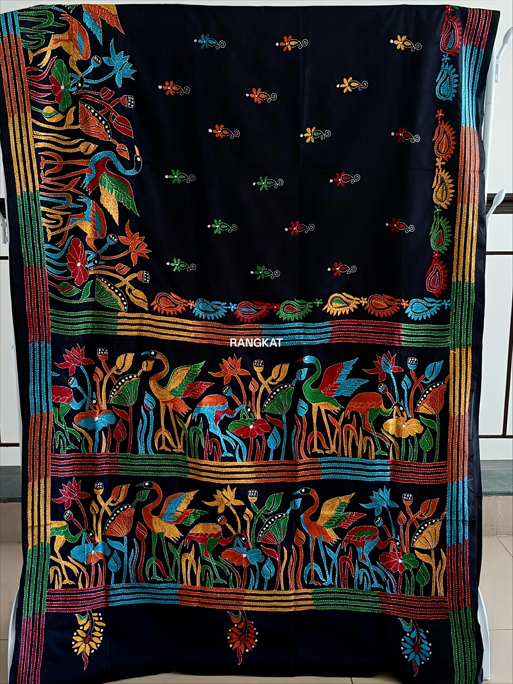 Colorful embroidered textile with intricate patterns on a black background
