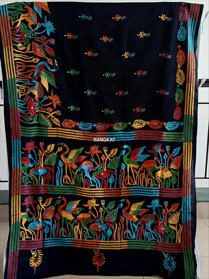 Colorful embroidered textile with intricate patterns on a black background